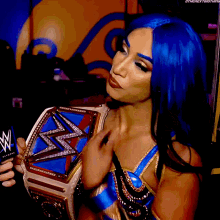 a woman in a blue wig is holding a wwe championship belt
