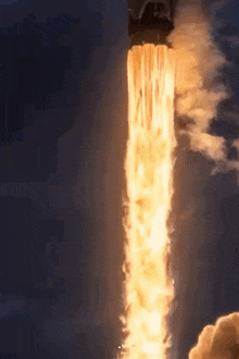 a rocket is being launched into the sky with a lot of flames coming out of it .