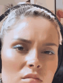 a close up of a woman wearing headphones and a headband