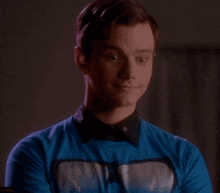 a man in a blue shirt with a picture of a whale on it