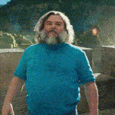 a man with a beard is wearing a blue shirt that says i. am spongebob