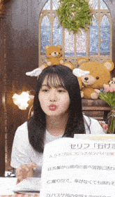 a woman with a teddy bear on her head and a sign that says a live