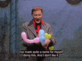 a man in a suit is holding balloons and says i 've made quite a name