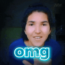 a woman in a blue shirt is smiling with the word omg glowing in the background