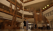 a man and woman standing in front of a large sculpture of a horse