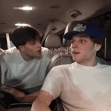a man in a blue hat that says i 'm behind you
