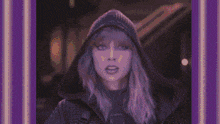 a woman wearing a hat is giving the middle finger in a pixelated image
