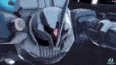 a robot with a red light on its head is flying in the air .