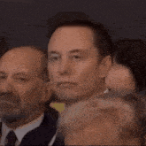 a man in a suit and tie is looking up at something