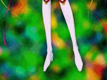 a close up of a person 's legs in white boots