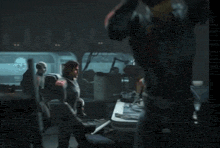 a group of people are standing around a table in a room