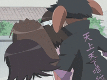 a man with chinese writing on his back is holding a woman