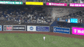 a baseball game is being played in a stadium with ads for ocean bank and t mobile