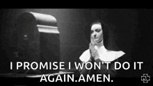 a black and white photo of a nun praying in front of a tv .