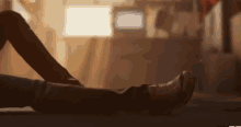 a person is laying on a bed with their feet up and their legs crossed .