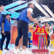 a man is standing in front of a jersey that says 23