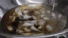 a pot of water with ice cubes in it and the words made in animatica on the bottom