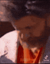 a close up of a man 's face with a tiktok watermark on the bottom