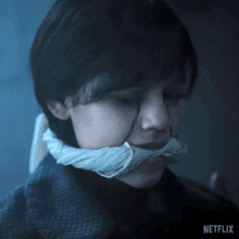 a close up of a person 's face with a netflix logo in the lower right corner