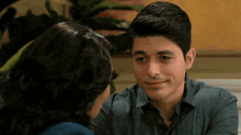 a man and woman are looking at each other and the man is smiling