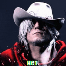 a man wearing a cowboy hat and a red jacket with the word het on it .