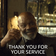 a man in a suit is holding a glass of whiskey and smiling with the words thank you for your service behind him