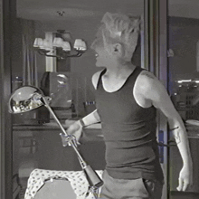 a man in a black tank top has a tattoo on his arm that says " i love you "