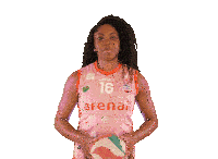 a woman is holding a volleyball in her hands and smiling for the camera