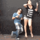 a man and a woman are dancing together and the woman is wearing a shirt that says sorry girl