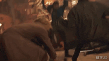 a group of people are dancing in a bar with a netflix logo on the bottom of the screen .