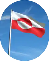 a red and white flag with a circle in the middle is waving in the wind