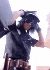 a police officer is wearing a helmet and sunglasses while holding a gun