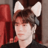 a close up of a person wearing a cat ear headband