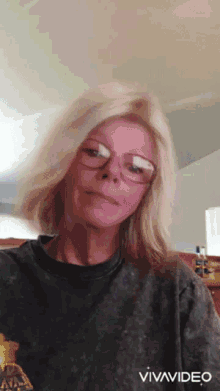 a woman wearing glasses and a t-shirt that says nba