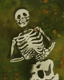 a skeleton is laying in the grass with a flower in his hand