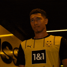 a young man wearing a yellow shirt with bvb on it