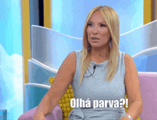 a woman sitting on a couch with the words " olha parva " on the bottom