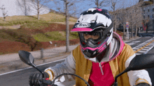 a person wearing an arai helmet rides a motorcycle