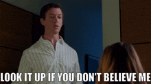a man stands in front of a woman and says look it up if you don 't believe me