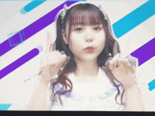 a girl with purple hair is making a peace sign in front of purple and blue stripes