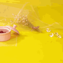 a person is putting a raspberry on top of a chocolate cup cake .