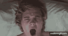 a man laying on a bed with his mouth open