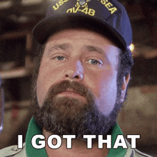 a man with a beard wearing a uss sea hat says " i got that "