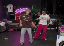 a man wearing a martine shirt is dancing in a living room
