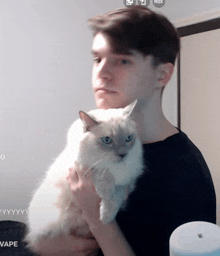 a man is holding a cat in front of a screen that says " vape " on it