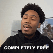 a man in a black hoodie says completely free with his eyes closed