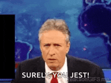 a man in a suit and tie is saying surely you jest .
