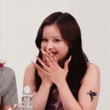 a woman with a dragon tattoo on her arm
