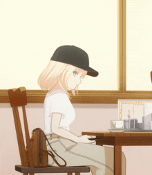 a girl is sitting at a table with a sign that says coffee