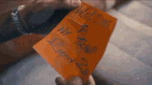 a person holding a piece of paper that says welcome my trap